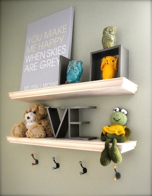 These floating shelves from Home Depot were exactly what we needed to display some of our sweet nursery items. The bear and frog were done by my paternal grandmother - so cute! The hooks below are also from Anthropologie and are now adorned with all our little girls' bows (and there are plenty!)